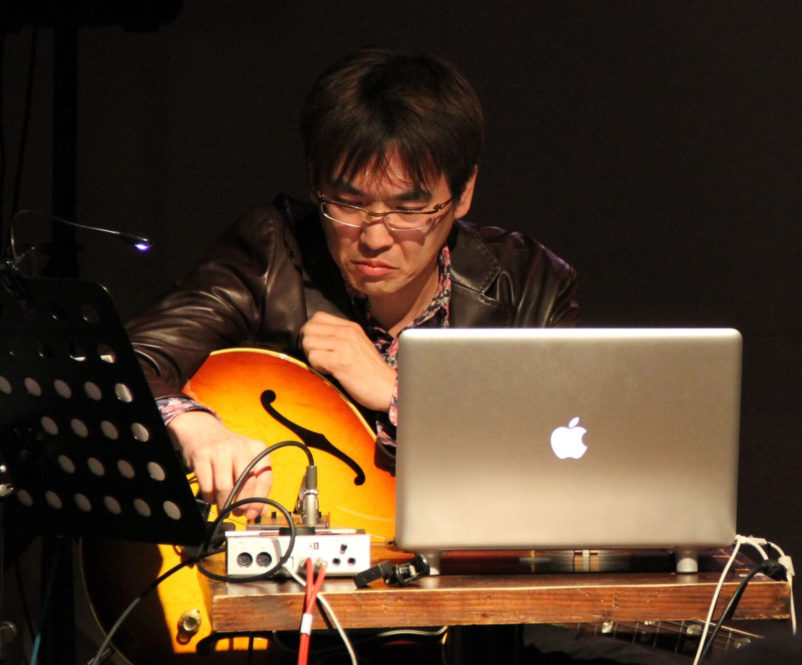 Yasuhiro Otani performing with guitar and laptop